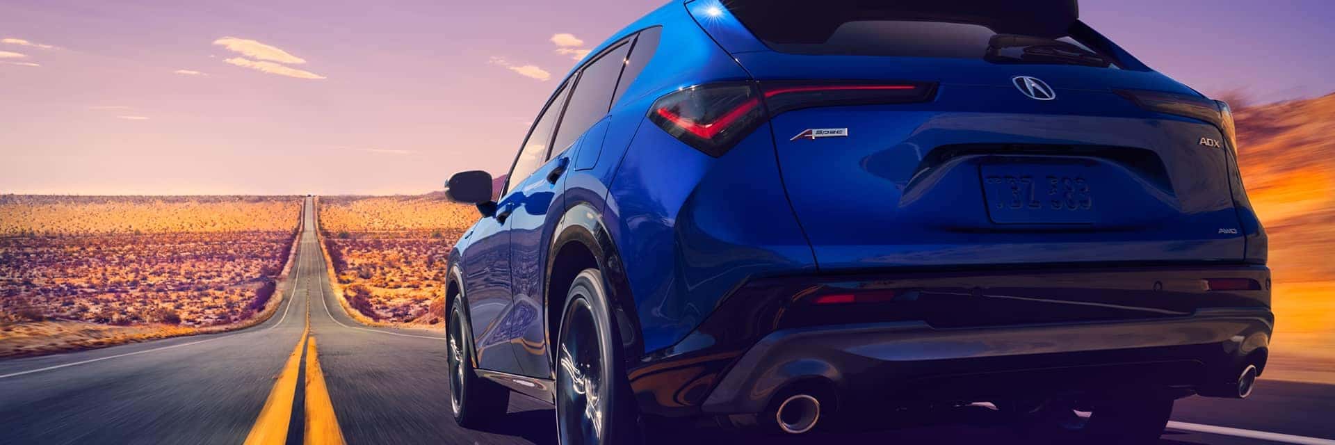 blue acura adx rear shot driving down hill