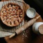 Pie, rolling pin, flour on wooden table