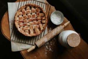 Pie, rolling pin, flour on wooden table