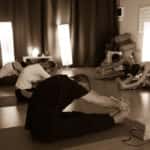 group of people doing hot yoga in a yoga studio