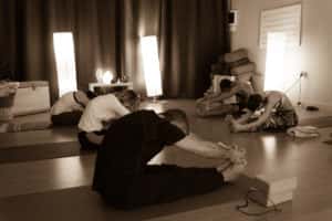 group of people doing hot yoga in a yoga studio