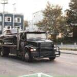 black truck on road during daytime by Jonathan Cooper is licensed with Unsplash License