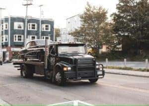 black truck on road during daytime by Jonathan Cooper is licensed with Unsplash License
