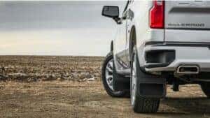2024 Chevy Silverado 1500 in white paint photographed from behind showing its taillight and rear profile.