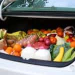 Lots of fresh food in the trunk of a car