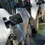 Row of cars at an electric charging station