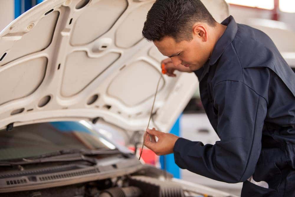Mechanic Checking Oil on a Dipstick