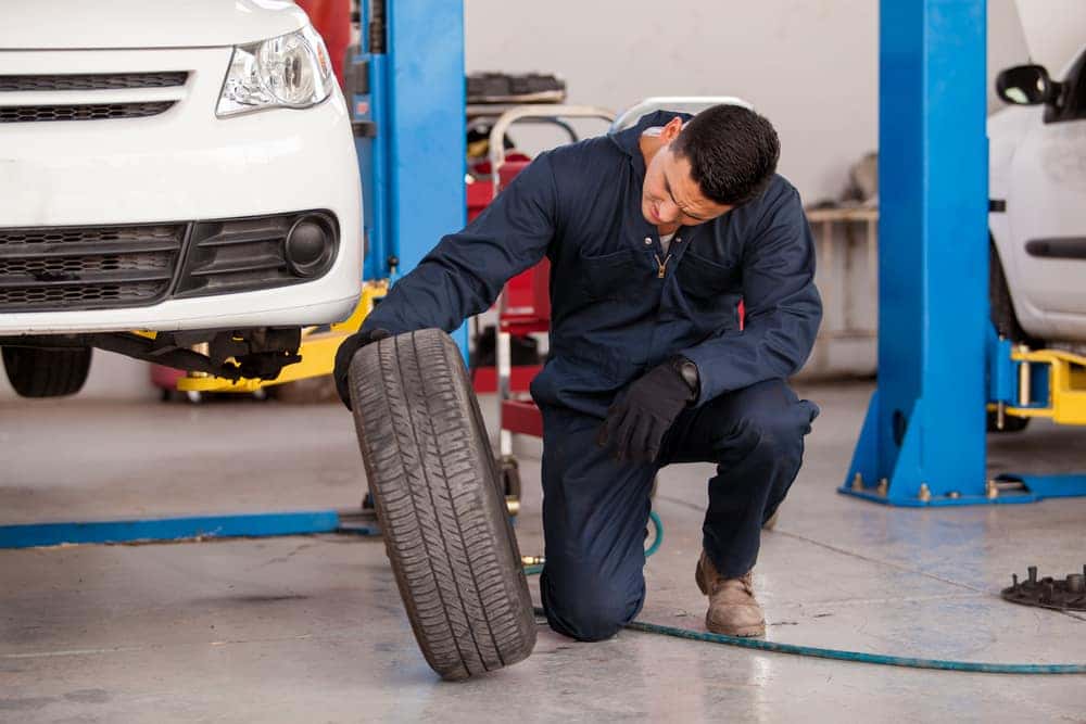 Mechanic looking at an old tire