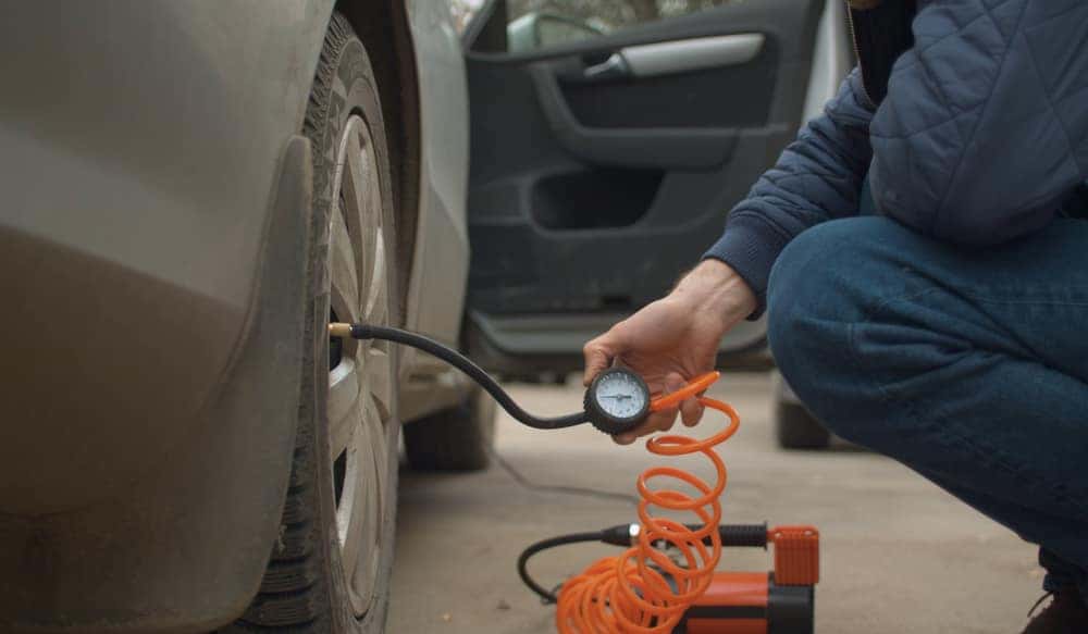 Man checking tire pressure