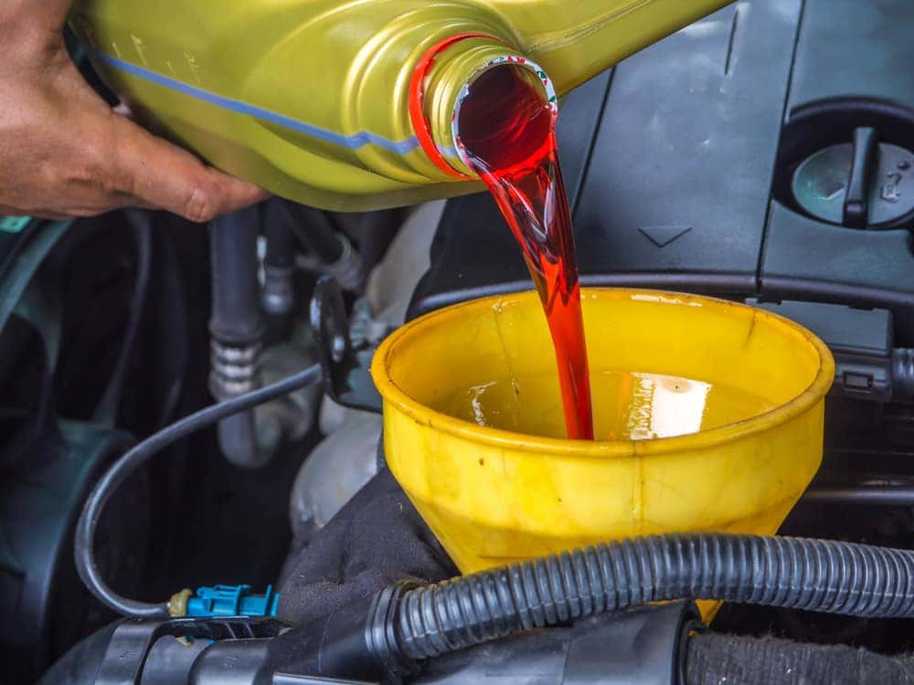 Pouring Transmission Fluid Into an Engine