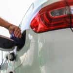 Man putting fuel additive into a gasoline tank