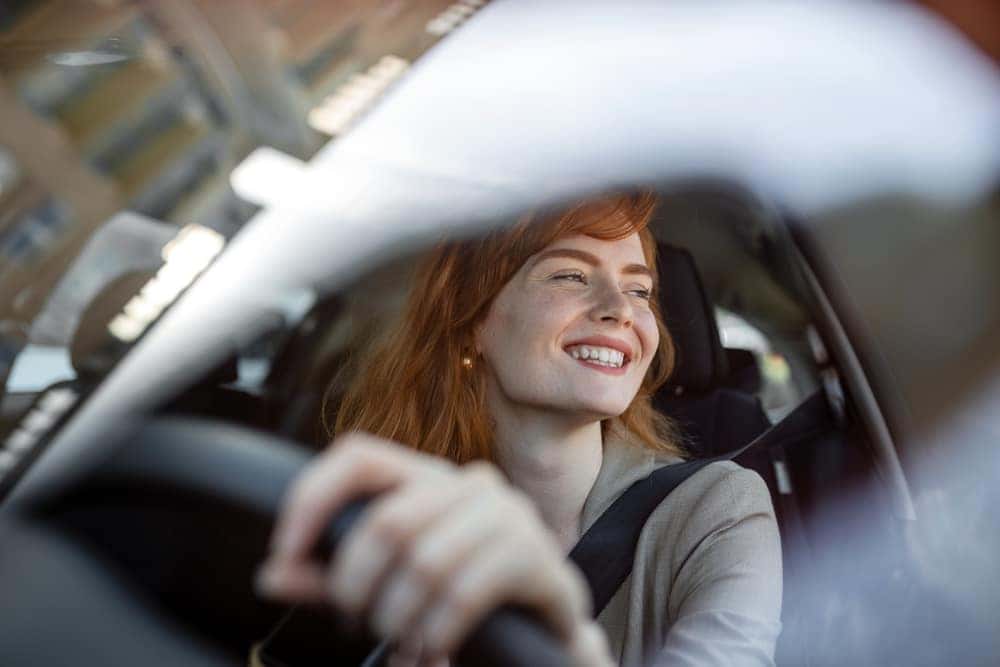 Young Woman Driving New Vehicle