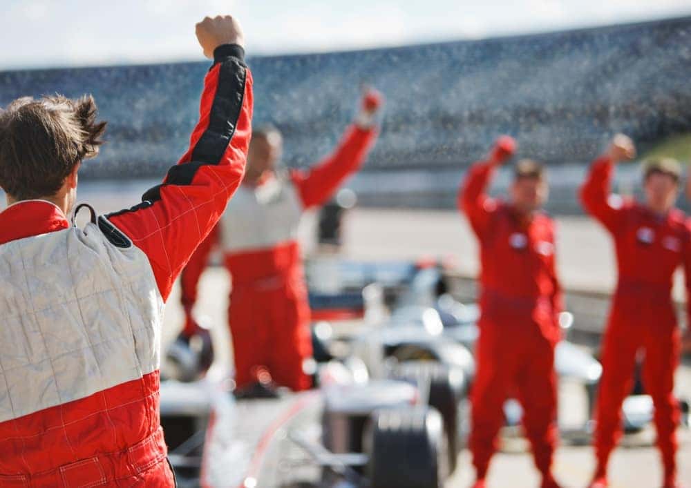 Racing Team Cheering on a Driver on Pit Lane