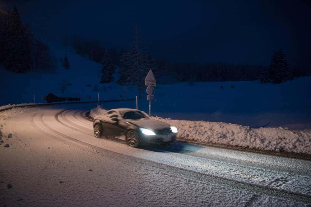 Car Driving at Night on Road in Winter