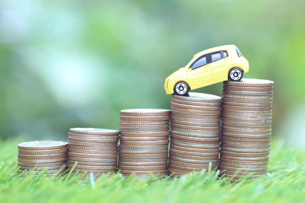 Depreciation Concept Car on Stack of Coins