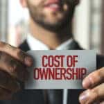 Man Holding a Cost of Ownership Sign