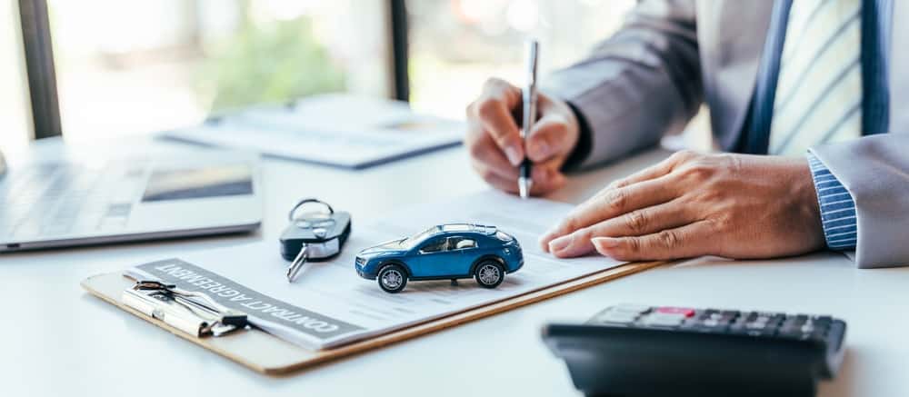 Man Signing Auto Loan Papers