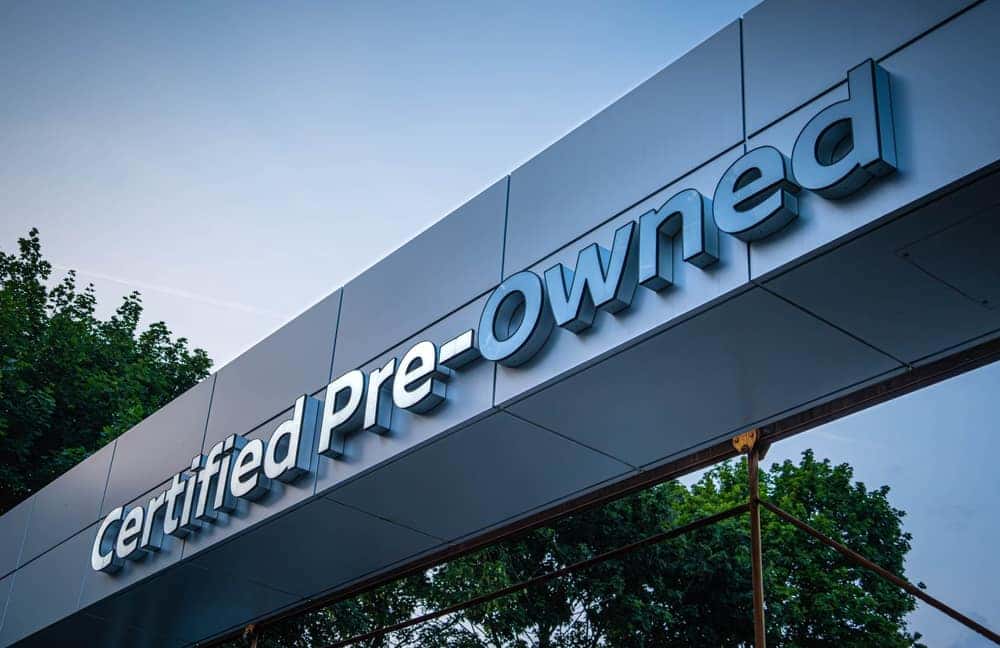 Certified pre-owned used car sign on a building