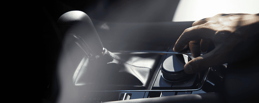 Hand using Mazda Connect in 2019 Mazda3 sedan
