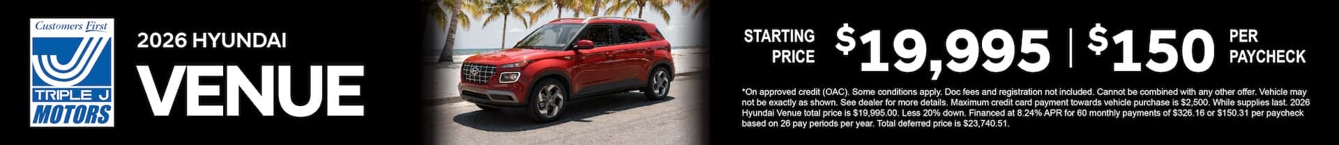 A red 2026 Hyundai Venue parked by the beach