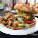 Deluxe Burger with Fries on a White Plate