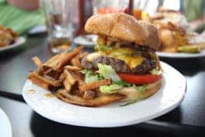 Deluxe Burger with Fries on a White Plate