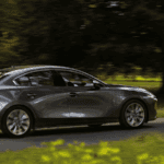 2019 Mazda3 driving down tree-lined street