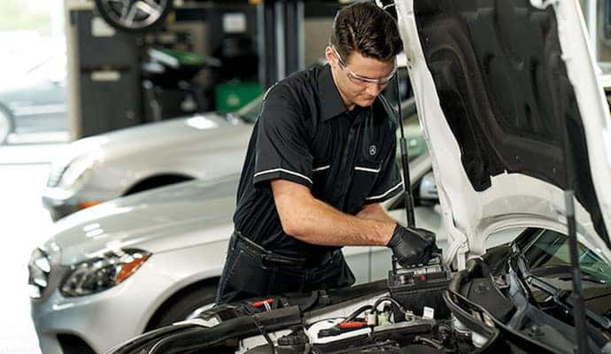 Mercedes-Benz technician replacing car battery