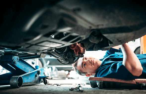 man repairs brakes near corona