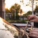 Technician changing windshield wipers