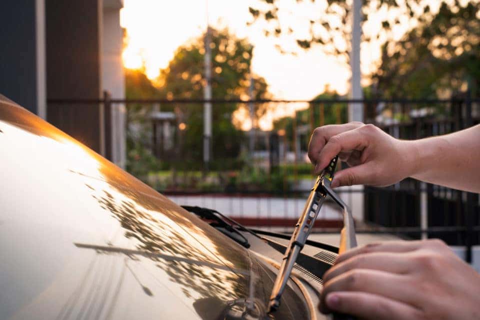 Technician changing windshield wipers