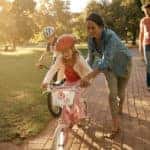 family park kid learning to ride bike
