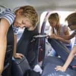 Kids cleaning out the interior of the family vehicle
