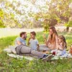 Family enjoying summer picnic in the nature